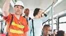 Photograph of people inside a bus holding onto the handrails