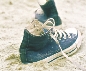 Photograph of a pair of sneakers in the sand