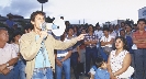 Photograph of a man talking to a crowd through a megaphone