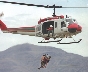 Photograph of someone being air lifted into a helicopter