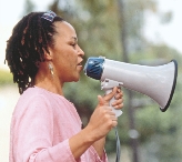 Photograph of a woman speaking into an megaphone