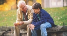 Photograph of an older man talking to a younger man