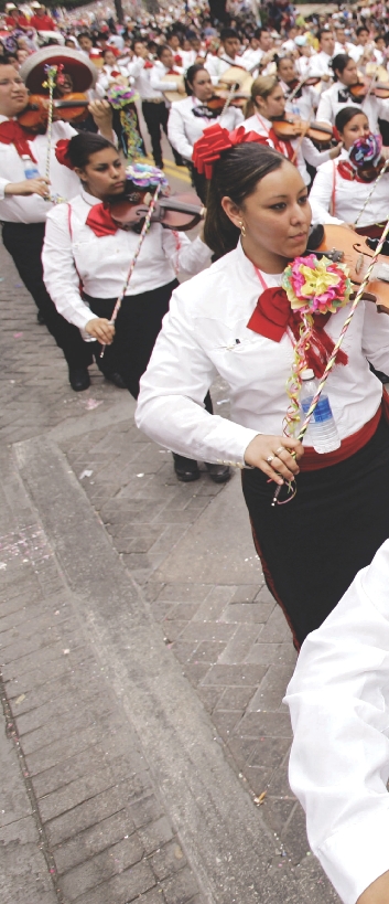 Photograph of people playing instruments in a marching mariachi band