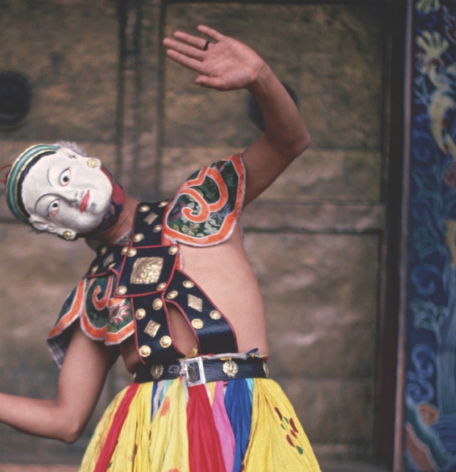 Photograph of a festival dancer from Bhutan wearing a mask