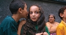 Photograph of a child whispering into another child ’s ear