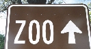 Photograph of a sign with the word “Zoo” and an upward pointing arrow on it