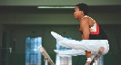 Photograph of a gymnast doing a routine on the even bars