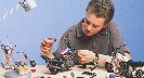 Photograph of someone putting together a model of a motorcycle