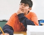 Photograph of a boy with his hand to his chin, thinking intently