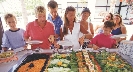 Photograph of a group of people at a salad bar with many selections