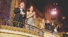 Photograph of audience at a theater standing and clapping