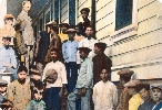 Chinese immigrants await health examinations outside a hospital, 1910.