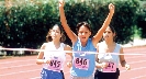 Photograph of a girl crossing a finish line after a race with arms held high