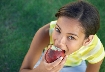 Photograph of a girl eating an apple