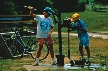 Photograph of two children at a handled pump, pumping water