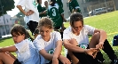 Photograph of members of a team sitting in a circle looking down at the ground