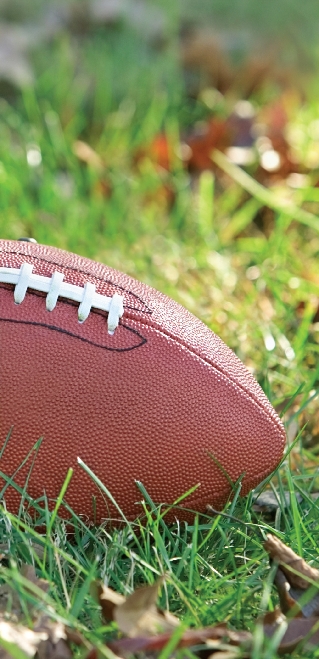 Photograph of a football laying in the grass