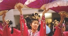 Photograph of a woman in traditional Asian dress dancing