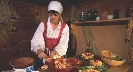 Photograph of a woman in an early kitchen re-enacting life of the early settlers