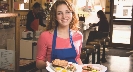 Photograph of a waitress in a restaurant bringing food