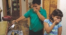 Photograph of a boy and girl near a trash can with their hand covering their noses