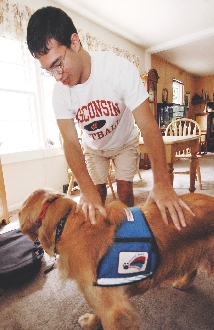 Andrew Brenes has cerebral palsy. He uses his service dog, Tonka, to regain balance.