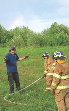 Aniak fire chief Pete Brown trains the girls how to fight fires.