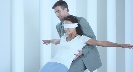 Photograph of a blindfolded person falling backward and being caught by someone standing behind her