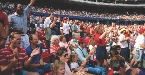 People support their team by attending a baseball game.