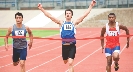 Photograph of runners at a race coming to the tape at the finish line