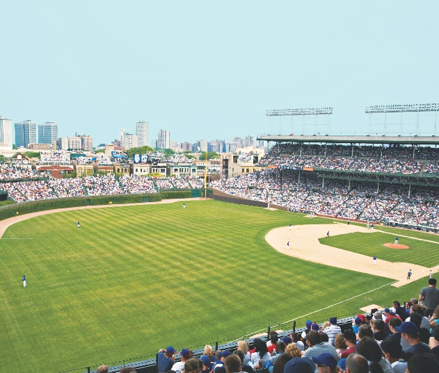 Photograph of a baseball game in a stadium as seen from the stands