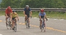 Photograph of several people riding bicycles