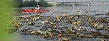 Photograph of a polluted lake with trash in it