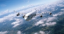 Photograph of a jet with clouds below it