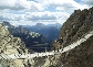 Photograph of a wooden footbridge linking one mountain to another