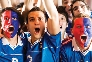 Photograph of several people with painted faces cheering in a crowd