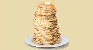 Photograph of an enormous pile of pancakes on a plate