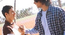 Photograph of two teenagers clasping hands