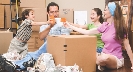 Photograph of a few people using a cardboard box as a table