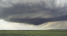 Photograph of grey thunderclouds over a field