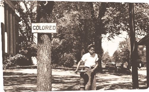 A child uses a drinking fountain outside of a North Carolina courthouse. In the 1950s, segregation controlled the everyday lives of most African Americans.