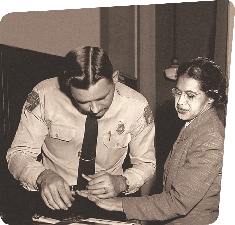 Rosa Parks is fingerprinted at the police station.