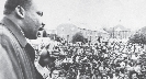 Photograph of Martin Luther King, Jr in front of a large crowd