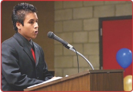 Photograph of a teenager giving a speech at a podium