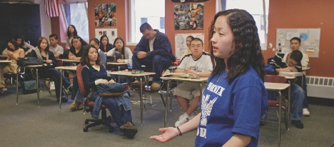 Eve Vang speaks to a group of students about school pride.