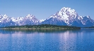 Photograph of snow-topped mountains and lake