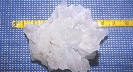 Photograph of quartz being measured with a measuring tape