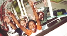 Photograph of people riding a roller coaster