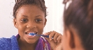 Photograph of a girl brushing her teeth