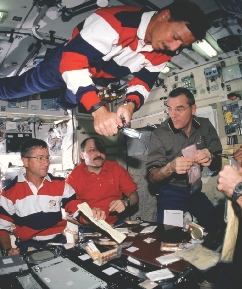 Astronauts share a meal on the International Space Station (ISS).